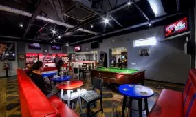 Comfortable seating inside the pool bar with plasma tv's.