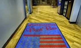 The Wombourne Pool Bar welcome mat with American flag.